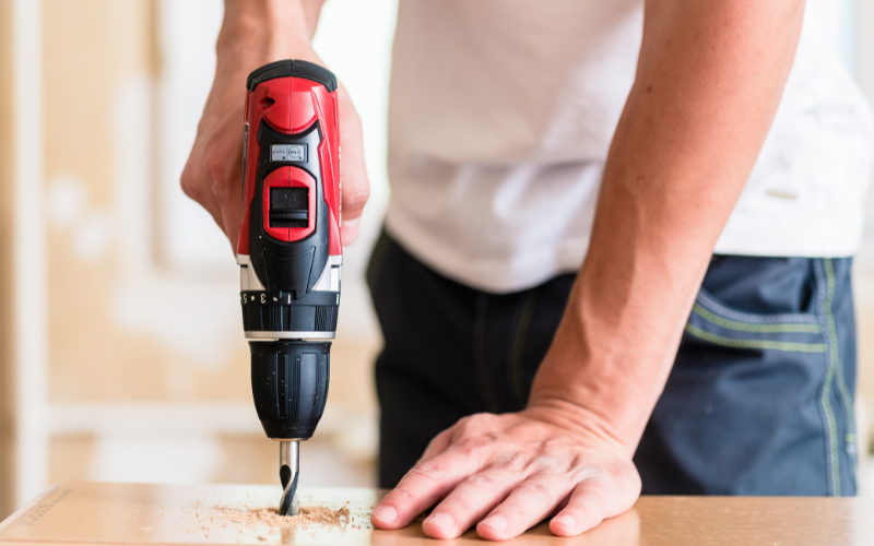 Red power drill being used