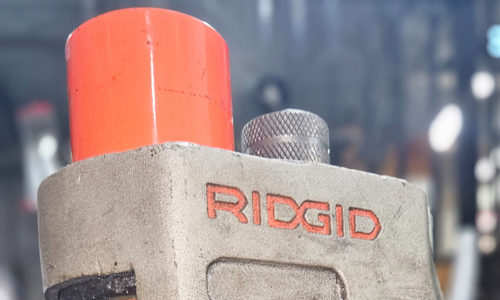 Pipe being grooved by Ridgid machine