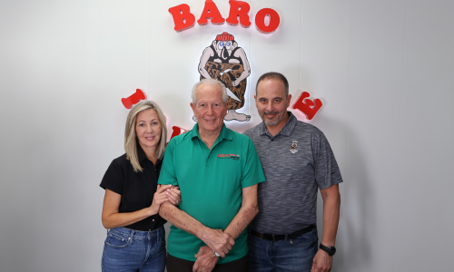 Baro Hardware staff in front of a Baro sign